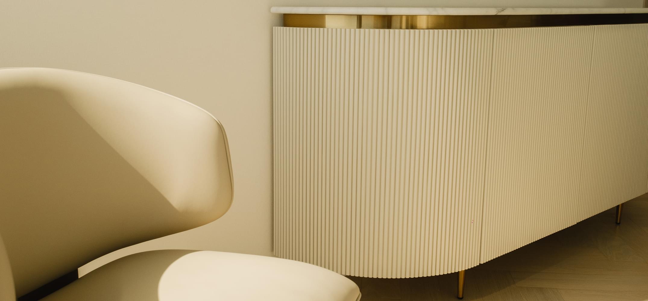 Elegant white sideboard with gold accents and a chair, part of TaskForce's Fit-Outs and Renovations in Dubai.
